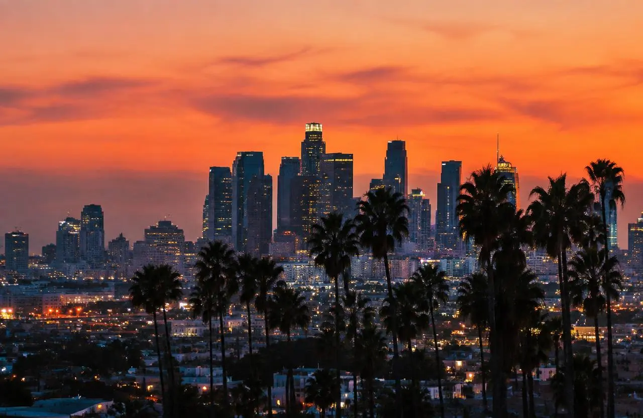 Downtown Los Angeles skyline with palm trees at dusk
